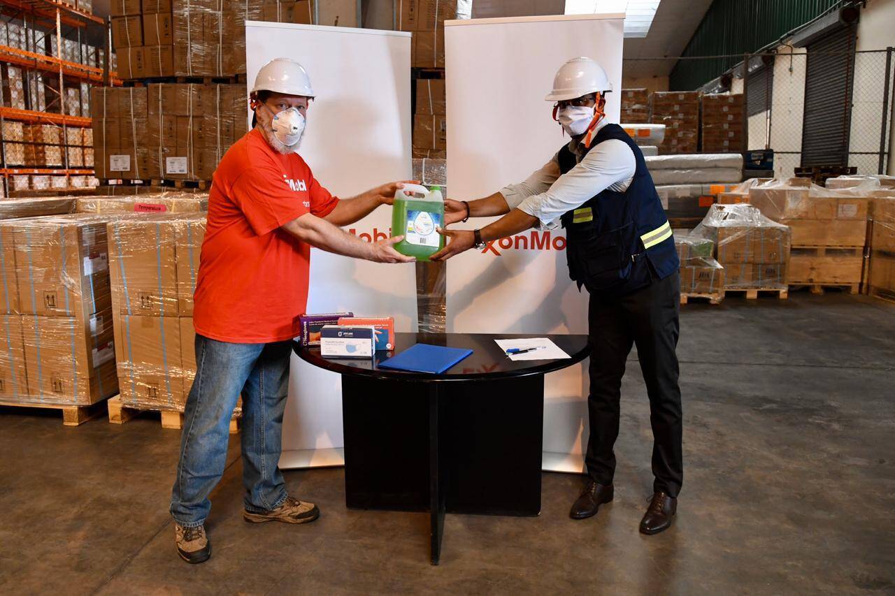 Security Health and Environment Manager Al Robb presents supplies toDr. Sérgio Seni, Deputy Director of the National Medical Center